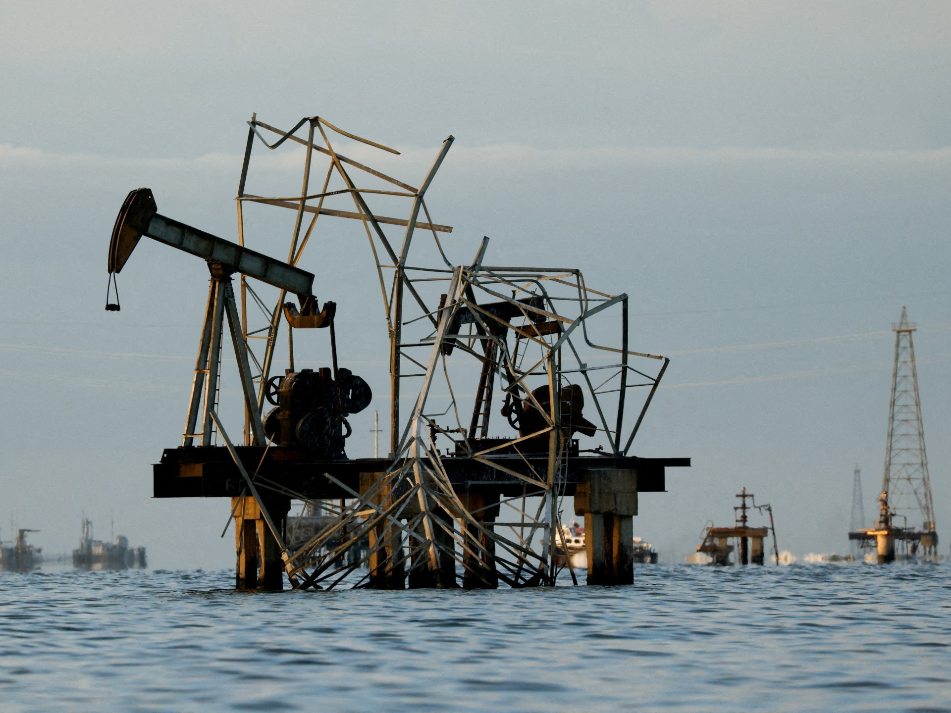 Abandoned pumpjacks damaged over time at a field of state oil company PDVSA on Lake Maracaibo in Venezuela [File: Leonardo Fernandez Viloria/Reuters]